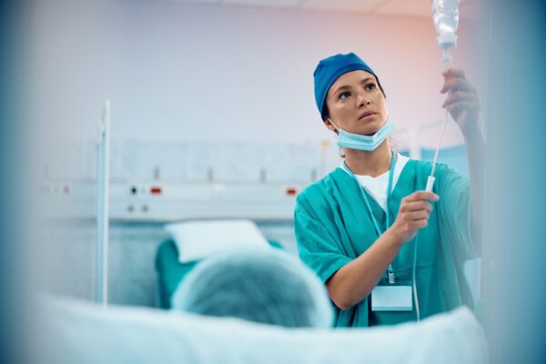 Mid Adult Nurse Taking Care Of A Patient