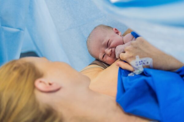 Baby On Mother's Chest Immediately After Birth In A Hospital