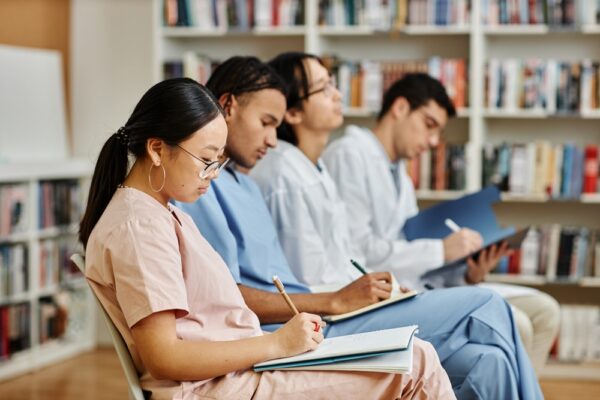 Diverse Group Of Medics In Row Sitting In Audience