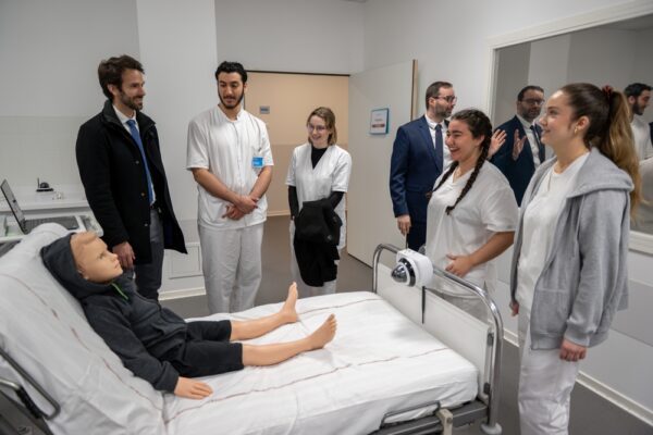 Students Look At A Robotic Medical tool