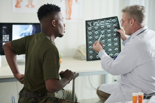 Doctor Talking To Soldier About Back Pain