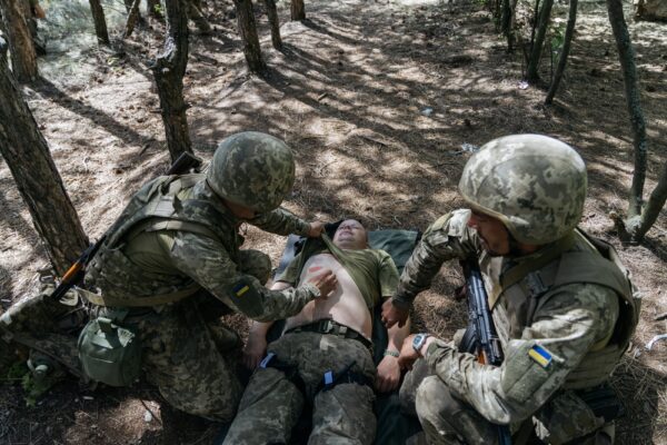 soldier receiving treatment in warzone