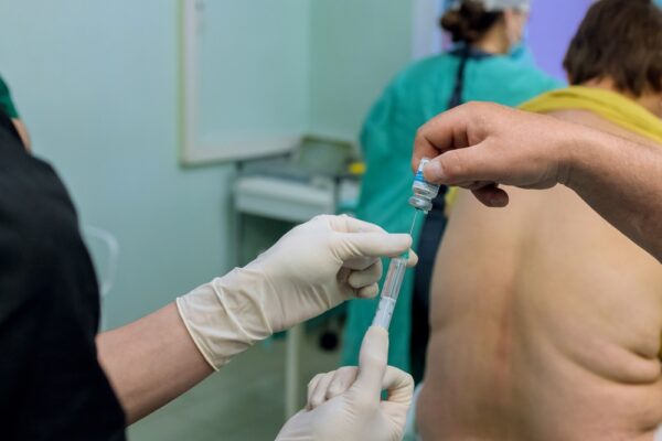 Doctor Administers Epidural Spinal Anesthesia Injection