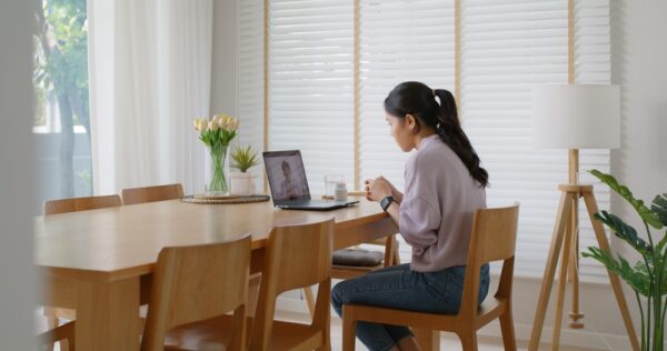 Young Woman Listening to Medical Exam Results At Home